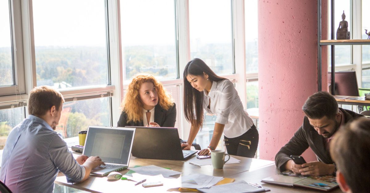 Two woman collaborating in front of a laptop